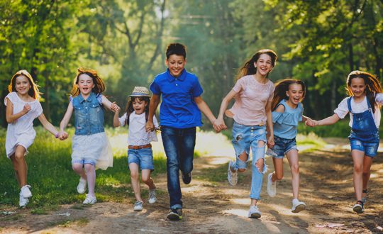 A group of children running down the road